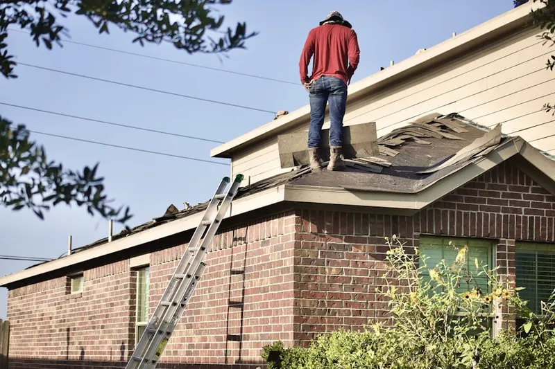 Professional roofer working on a residential roof in Cornelius